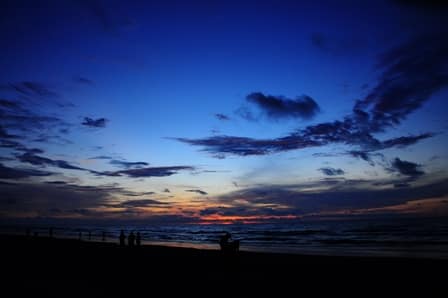 The sheltered sandy bay and treeline at Luak Esplanade near Miri