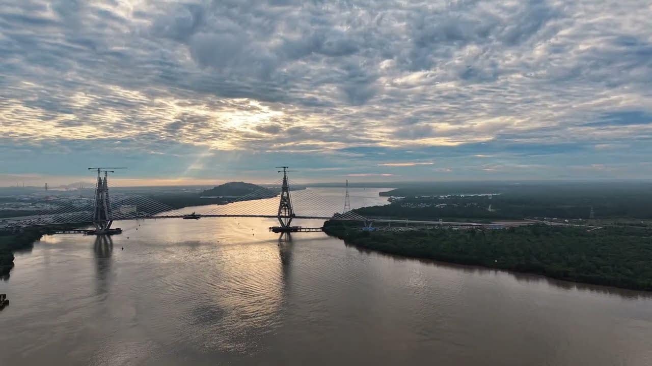 Aerial view of the cable-stayed Sejingkat Bridge and its two pylons crossing the Sarawak River at first light
