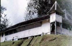 The white timber walls, shuttered windows and shingled roof of Fort Alice at Sri Aman