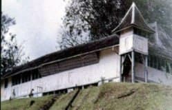 The white timber walls, shuttered windows and shingled roof of Fort Alice at Sri Aman