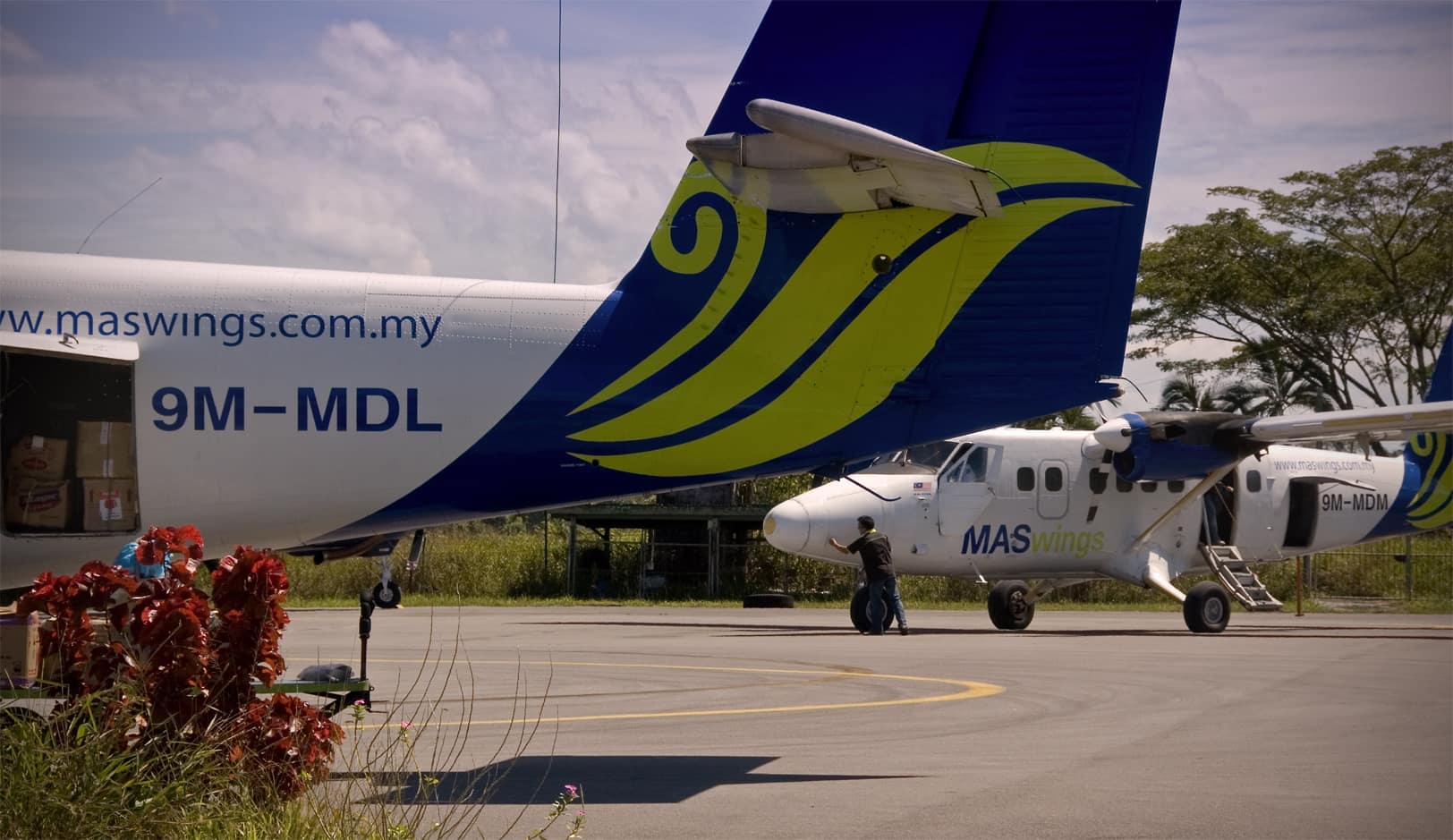 Twin Otters 9M-MDL and 9M-MDM, taken during a brief stop at Marudi (MUR) airport in Sarawak, Malaysia, on the island of Borneo. Larger MASwings provides the Rural Air Services (RAS) in East Malaysia. We were flying on 9M-MDL, heading towards Bario (BBN), having left Miri (MYY) about 10 minutes earli