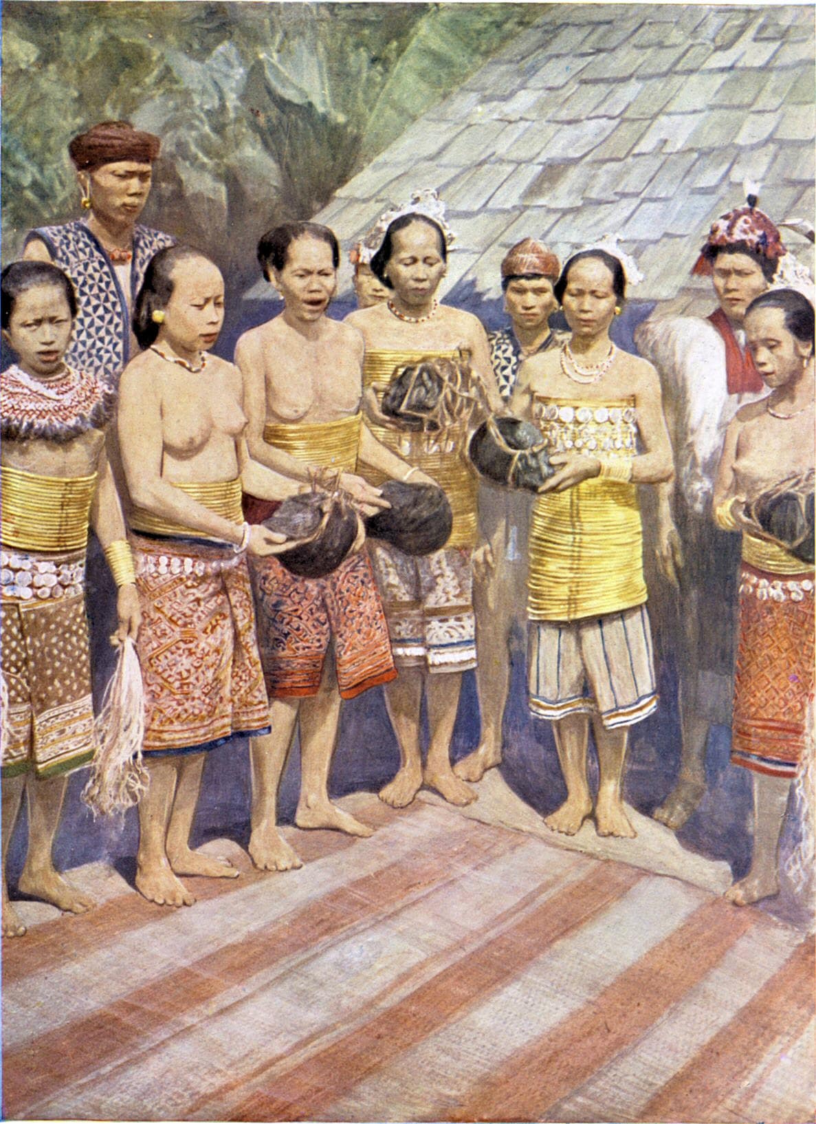 Dayak women dancing with human heads. A few days after the return of a successful head-hunting expedition, the heads, which have been hacked off the dead bodies, are brought triumphantly into the house. Then follows a time of rejoicing, in the course of which the heads are taken by the woman who, ha