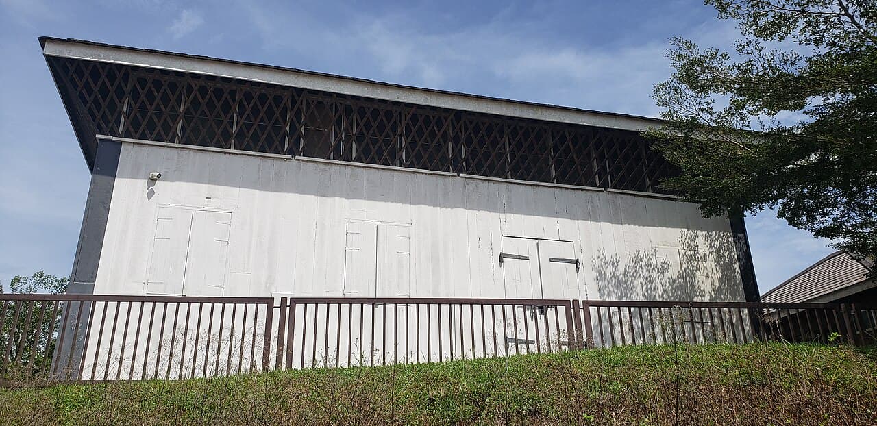 The timber walls and shingled roof of Fort Emma standing among trees at Kanowit