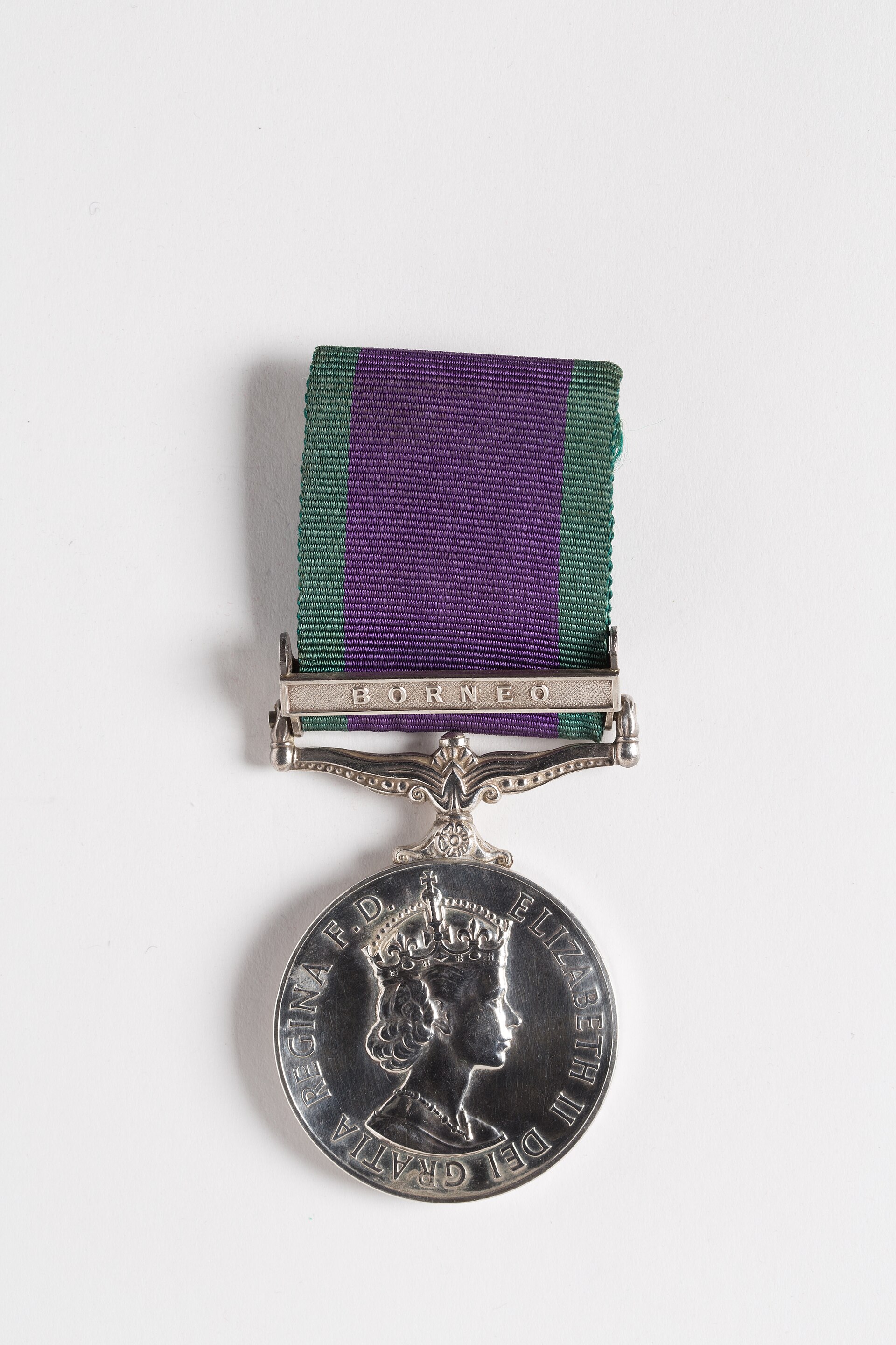 General Service Medal 1962- Medal awarded to 470097 Pte E. McKenzie, Royal New Zealand Army Medical Corps (RNZAMC) circular silver medal; ornate suspension with one bar BORNEO; with ribbon obverse- crowned head of Queen Elizabeth II facing right; legend around- ELIZABETH II DEI GRATIA REGINA F . D .