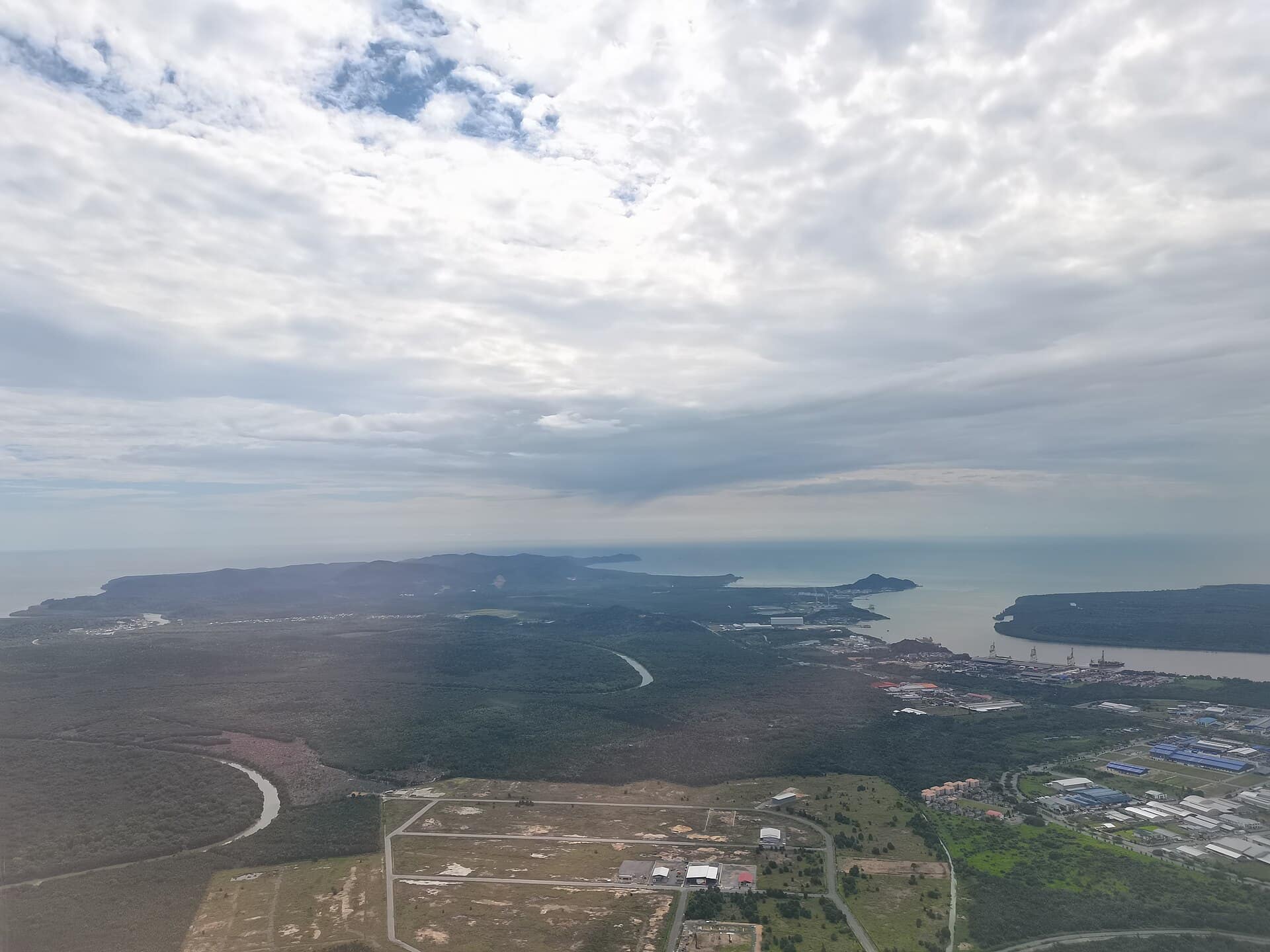 From near to far on the right side: Demak Laut Industrial Zone Phase III, Senari Port of the Kuching Port Authority, and mouth of Sarawak River. Left side: Bako National Park.