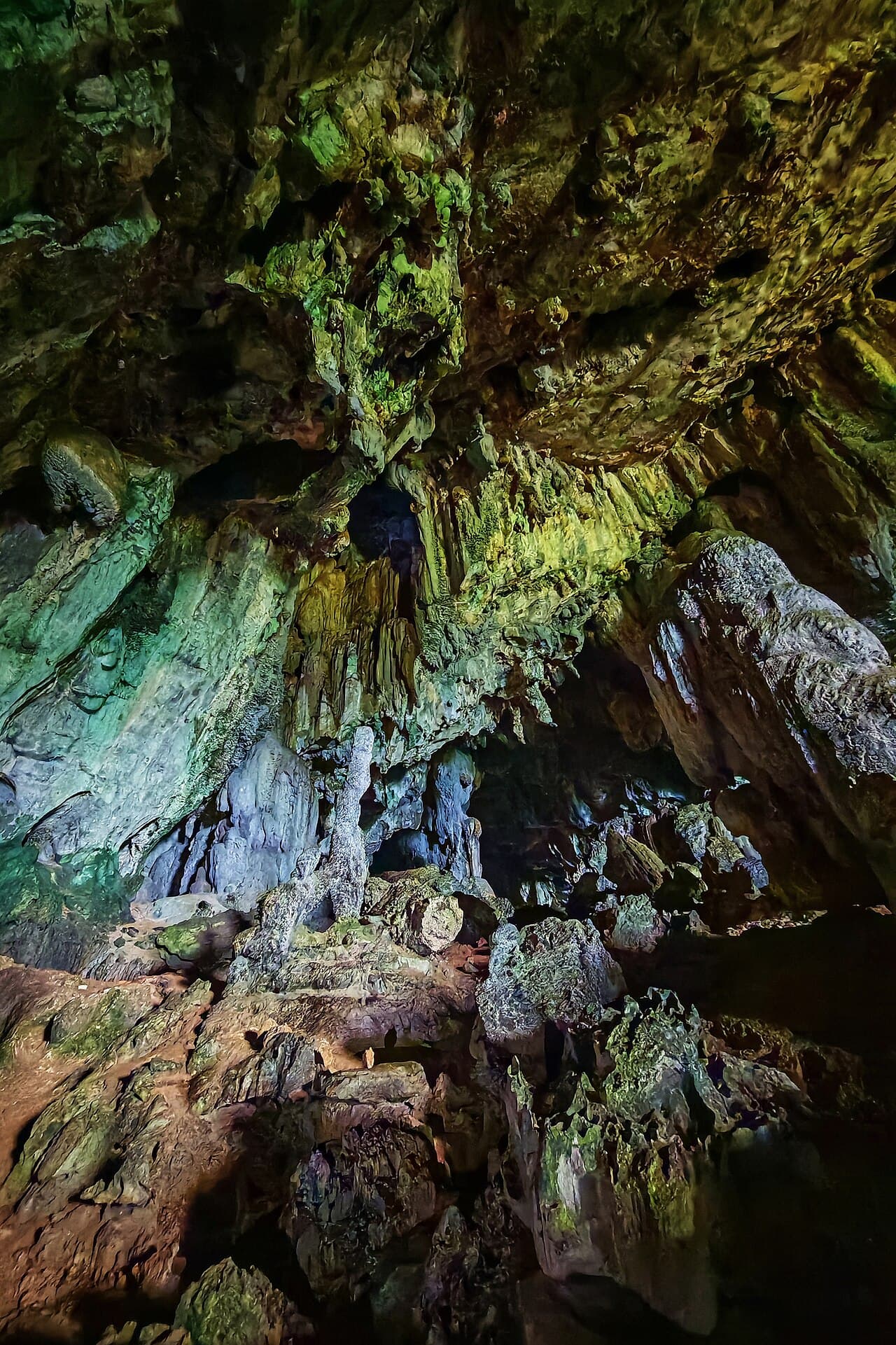 Daylight falling into the green-lit main chamber of Fairy Cave near Bau